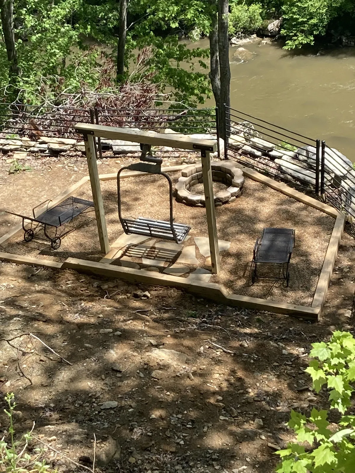 This inviting scene features a swing and a fire pit surrounded by multiple seating areas. The arrangement fosters an intimate, communal atmosphere ideal for gathering, sharing stories, or simply relaxing while enjoying the outdoors.